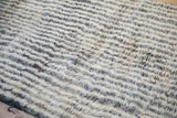 Shaggy pile texture of the Moroccan runner, with ivory, silver, and charcoal abrash.