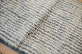 Plush ivory and charcoal pile of Moroccan rug, revealing prominent longitudinal abrashes.