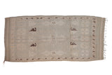 Distressed vintage Moroccan runner rug, pale seafoam green and dark chocolate geometric motifs.