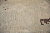 Distressed texture and dark brown geometric pattern on a vintage Moroccan runner rug.