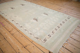 Distressed vintage Moroccan runner, pale seafoam geometric field, dark brown meandering border, fringed end.