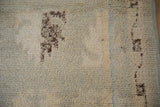 Distressed vintage Moroccan rug's shaggy ivory pile with dark chocolate brown areas.