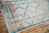 Vintage Moroccan runner fringe, worn blush pink bands, and turquoise stepped motifs.