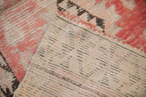 The hand-knotted foundation, knot heads, and blush pile of a vintage Moroccan rug runner.