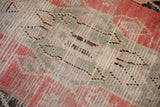 Close view of the hand knotted pile, showing exposed knot heads and the rug's foundation.