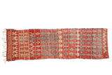 Vintage Moroccan runner with geometric diamond seed motifs in dusty cherry red, cream, and charcoal black.