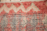 Varied texture of a vintage Moroccan rug showing areas of pile and exposed knot heads.