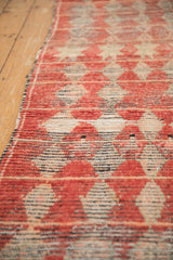 Close-up of the vintage rug's low pile, revealing hand-knotted texture and knot heads.