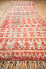 Perspective view of a vintage Moroccan runner showing abrashes across its geometric pattern.