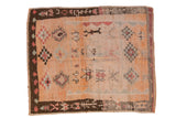 Vintage Moroccan carpet with checkered diamond medallions on a cantaloupe field with a chocolate brown border.