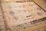Hand-knotted pile of a vintage Moroccan rug with checkered diamond medallions and color abrashes.