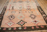 Low angle looking down the plush pile of a vintage Moroccan carpet with geometric patterns.
