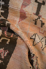 Plush hand-knotted pile of a Moroccan carpet with warm cantaloupe and cochineal color variations.