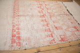 Distressed vintage Moroccan rug detail with textured pile, flatweave, and blush geometric patterns.