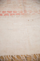 Hand-woven ivory flatweave with knotted fringe on a vintage Moroccan runner.