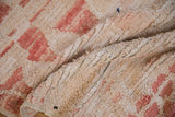 Distressed vintage Moroccan runner pile texture with ivory, blush pink, and knot heads.