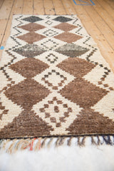 Vintage Moroccan runner close-up: ivory, natural brown, charcoal interconnected diamond pattern, visible fringe.