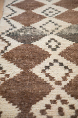 Textured hand-knotted pile of a Moroccan rug with natural brown and ivory diamonds.