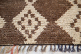 Vintage Moroccan runner: shaggy natural brown and ivory pile, showing geometric diamonds and fringe.
