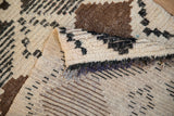 Vintage Moroccan rug foundation with tight weave, dark patterns, and folded shaggy pile.