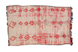 Vintage Moroccan carpet with columns of red and silver diamond medallions on an ivory wool field.