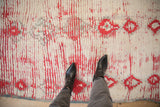 Plush hand-knotted pile of a vintage Moroccan rug with geometric diamond motifs in tomato red and silver.