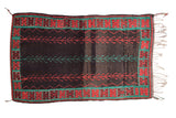 Vintage Moroccan rug with three central vines in red and turquoise on a heavily abrashed charcoal ground.