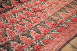 Plush, mostly even wool pile of a Moroccan carpet in pale red and charcoal.