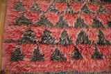 Plush, shaggy wool pile and restored side cord of a vintage Moroccan carpet.
