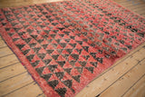 The plush, mostly even pile height and restored side cord of a vintage Moroccan rug.