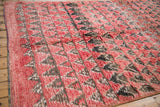 Angled view of the thick, shaggy wool pile and side selvage on a vintage Moroccan carpet.