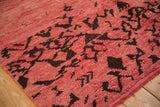 Even pile height and hand-knotted texture of a vintage Moroccan rug in raspberry red and brown.