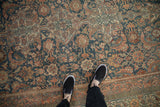 Distressed Bibikabad rug's faded navy, blush, and gold Herati pattern and even pile wear.