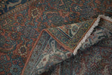 Distressed vintage Bibikabad carpet's worn Herati pattern, fringe, and hand-knotted foundation.