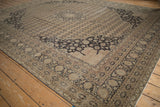 Distressed Sivas carpet corner with charcoal arabesque spandrel and coffee brown field's worn patterns.