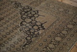 Vintage distressed Sivas carpet with arabesque palmettes, coffee brown field, and dark charcoal patterns.