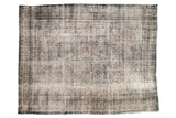 Vintage distressed Bibikabad rug, faded traditional Herati pattern, soft navy and ivory hues.