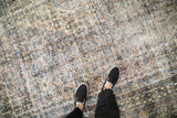 Distressed texture and muted blue, ivory, and sand tones on the vintage Bibikabad carpet.
