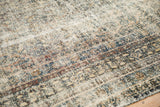 Distressed texture of the vintage Bibikabad carpet showing faded blue and cream hues.