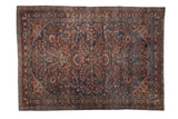 Distressed vintage Lilihan carpet, allover floral pattern in muted burgundy and navy. 6'2