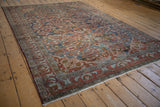 Distressed Lilihan carpet with burgundy floral sprays, charcoal navy field, and serrated leaf border.