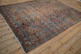 Distressed Lilihan carpet displaying muted floral sprays, abrash, and visible knot heads.