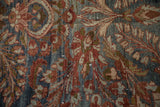 Distressed Lilihan carpet pile showing worn floral sprays and serrated leaves in burgundy and navy.