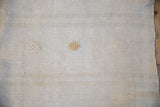 Textured beige Turkish hemp kilim with raised natural and tan decorative motifs.