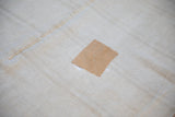 Light tan repair patch with white stitching on the seamed vintage hemp runner.
