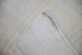 Central seam joining two hand-woven Turkish hemp kilim runners in pale sand tones.