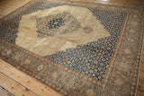 The intricate navy Herati spandrel meets the sandalwood border on this distressed Tabriz carpet.