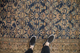 Distressed antique Northwest Persian runner showing Herati pattern, softened blues, and intricate vine border.