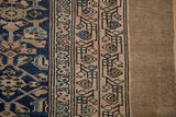 Distressed Northwest Persian runner: close view of geometric border, pile wear to knot heads, camel selvage.