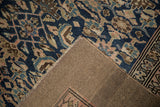 Antique distressed Northwest Persian runner corner: geometric Herati pile and woven foundation.